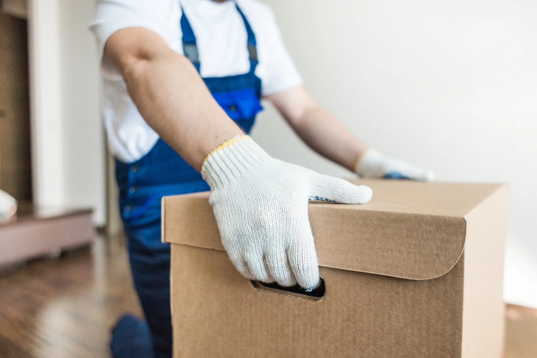 Mover carrying a moving box indoors